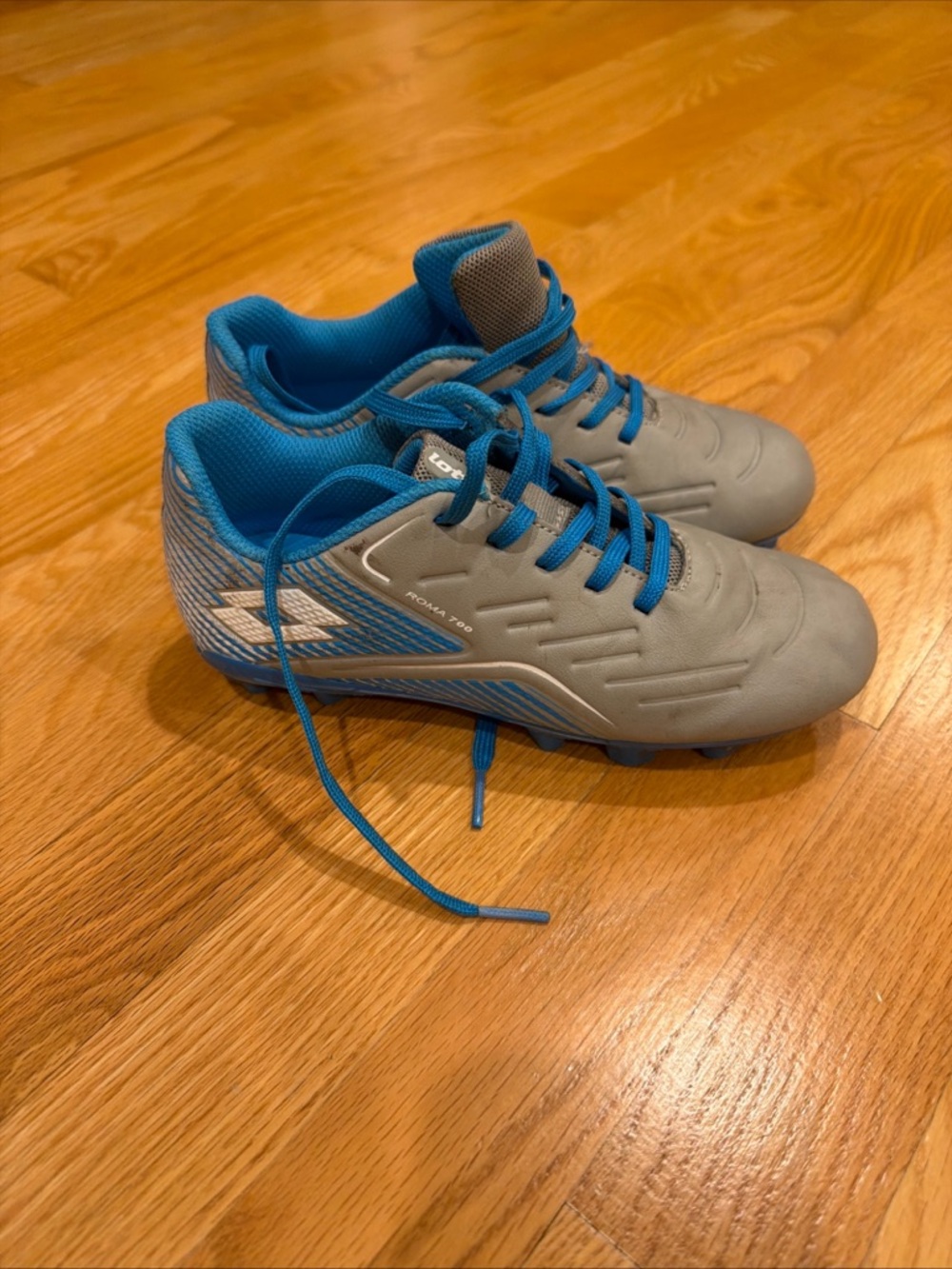 Kids Gray Soccer Cleats with Bright Blue Lining and Laces